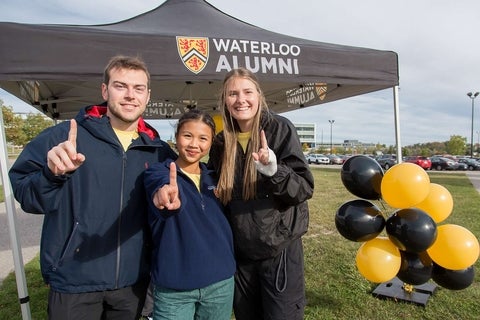 Students in front of a Waterloo Alumni tent