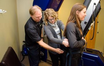 Dr. Jeff Goldsworthy instructs a co-op student on a chiropractic exam.