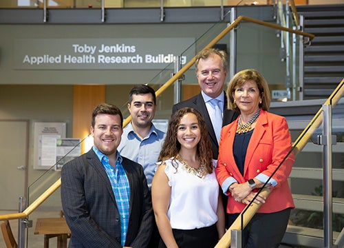 Toby Jenkins, Tom Jenkins and children at the Toby Jenkins Applied Health Research Building.