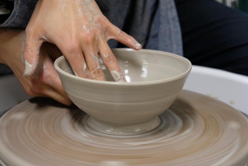 image of hands creating pottery