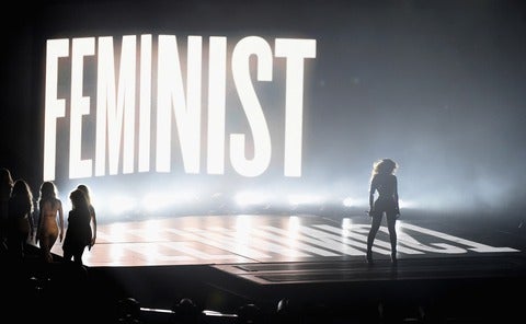 Beyonce on stage with the word 'Feminist' in lights