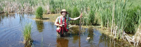 Adam Kraft taking depth measurements in an Alberta wetland.