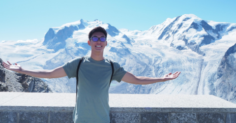 picture of andrew in front of a mountain range 