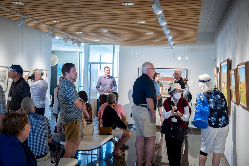 A tour group visits the Grebel gallery exhibit