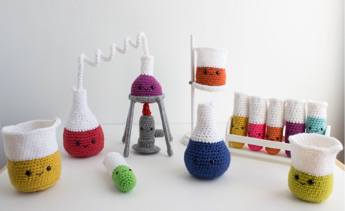 crocheted chemistry set with Bunsen burner, retort stand, beakers and test tubes