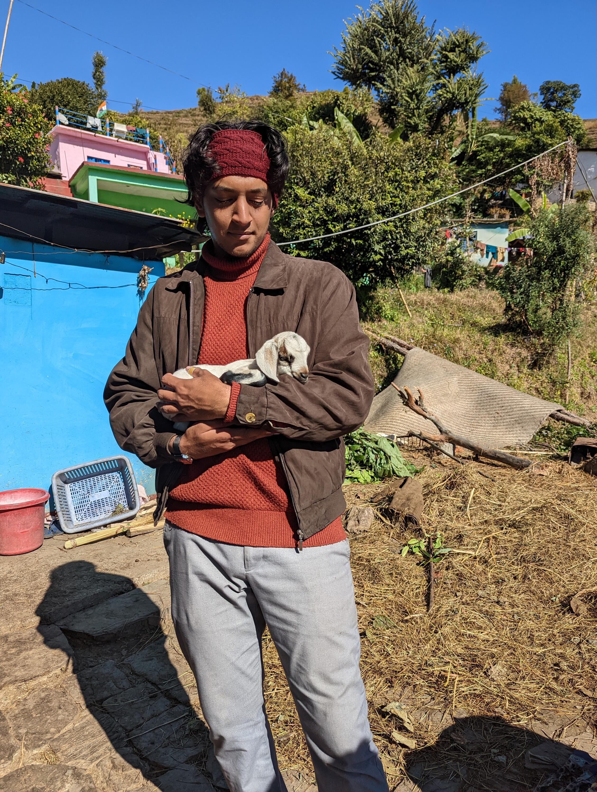 Aryaman holding a baby goat.