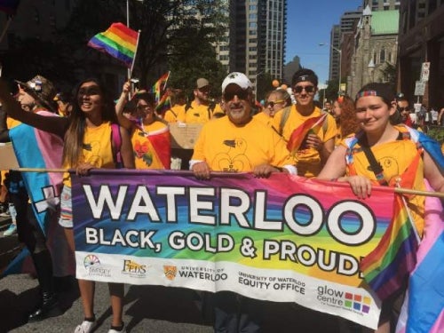 President Feridun Hamdullahpur marches in the Toronto Pride Parade with other Waterloo volunteers.