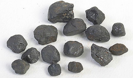 many pieces of dark rock (coltan)