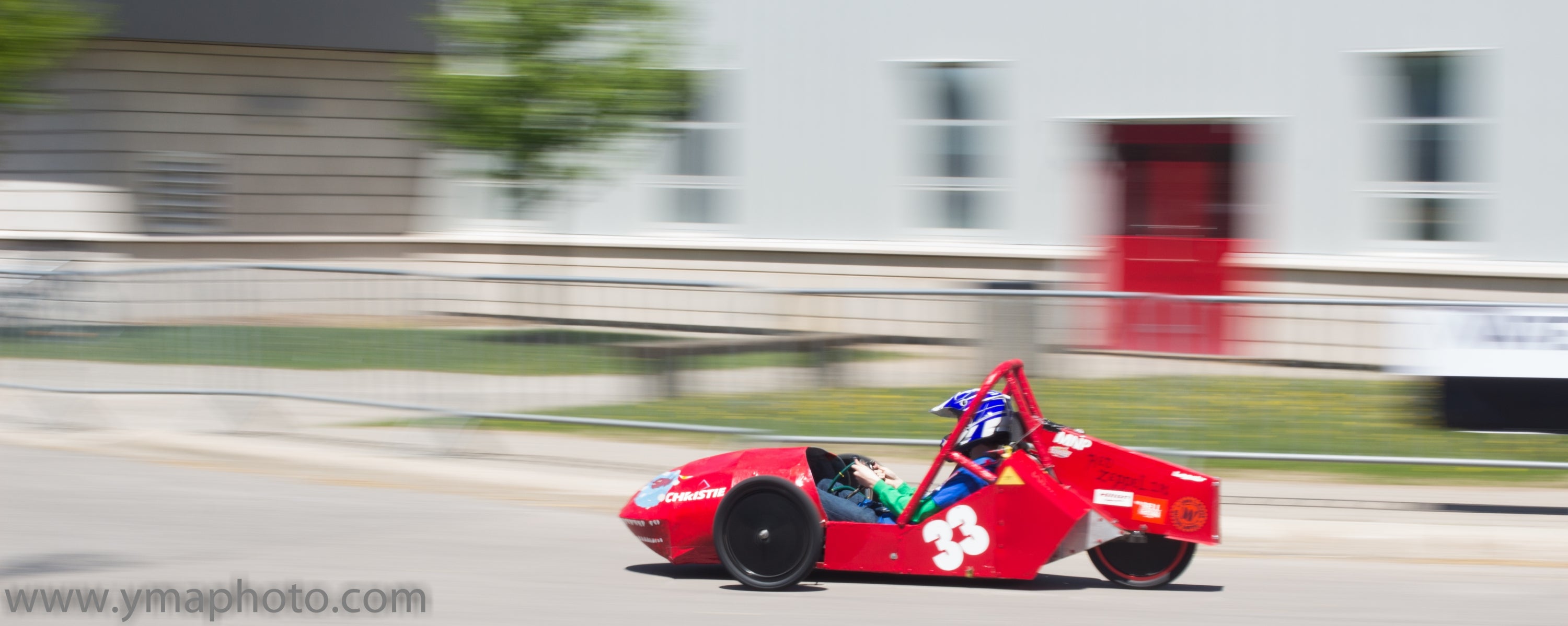 Red electric vehicle on race track