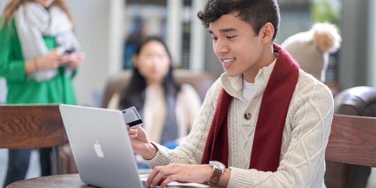 Student using credit card online.