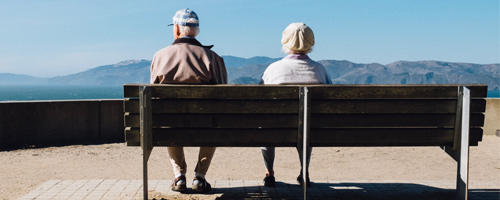 Seniors sitting on a bench.