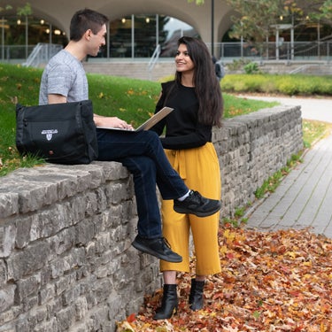 Two students chatting outside at the University of Waterloo