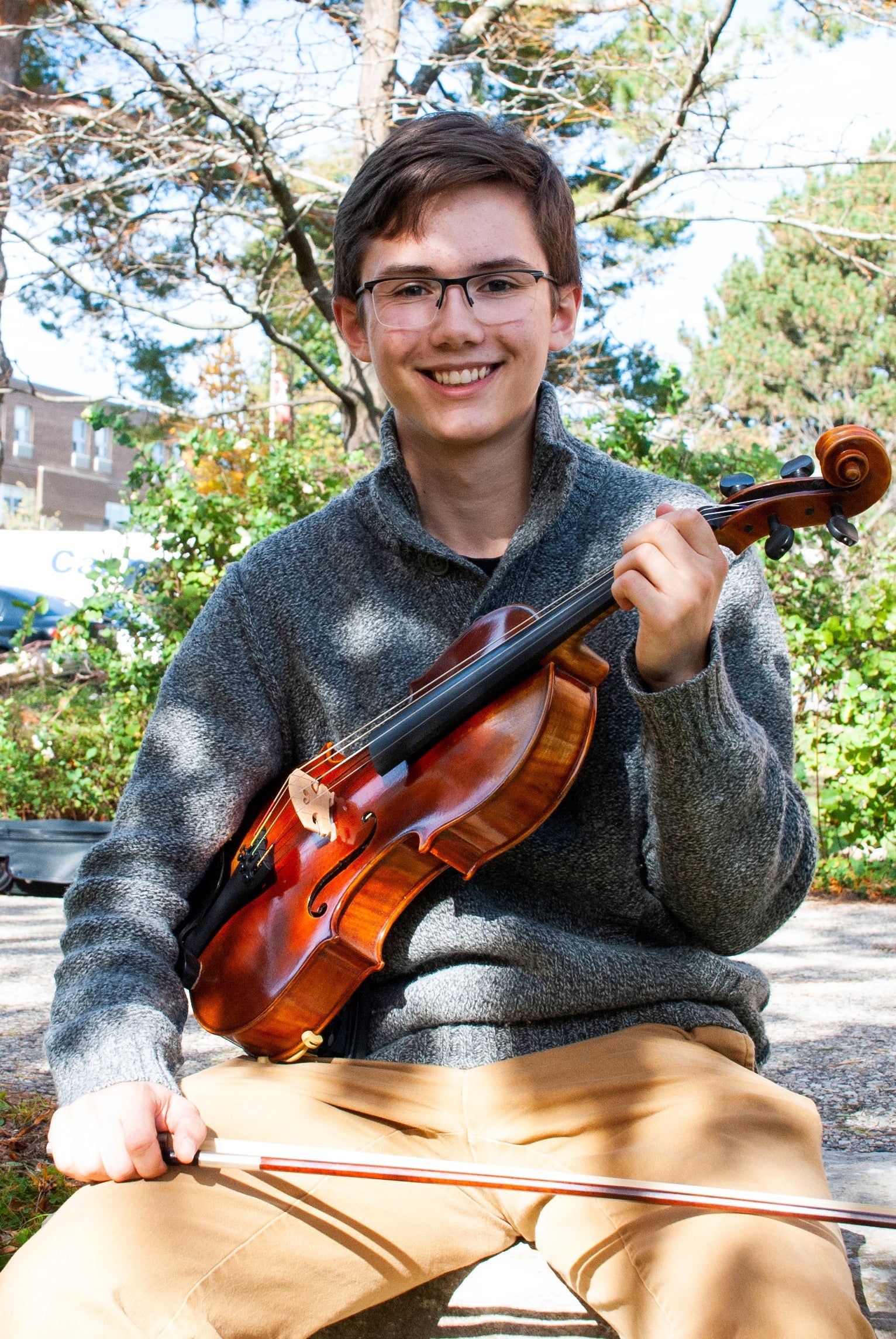 Stuart Matthews holdsing a violin
