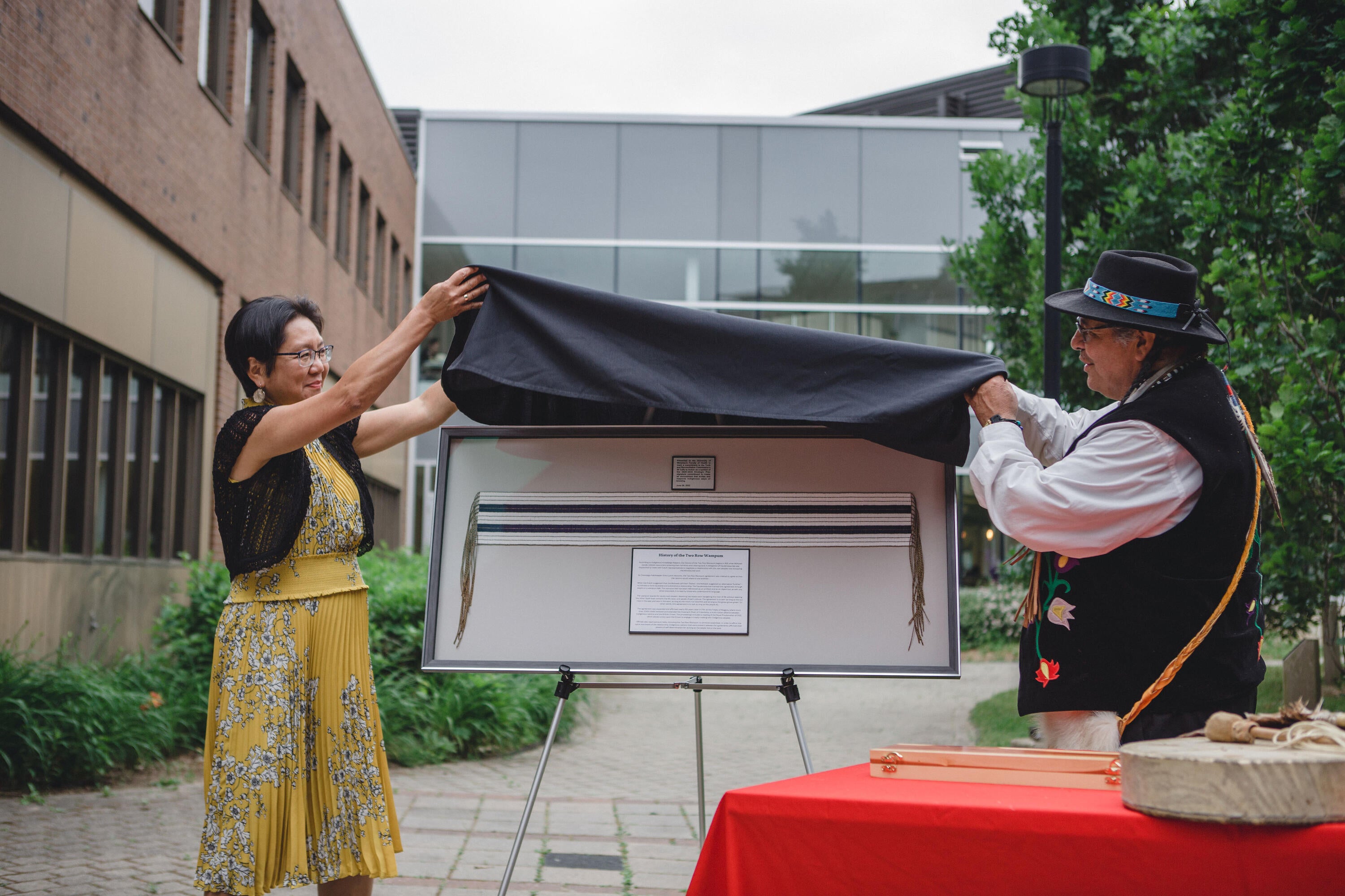Dean Liu and Elder Henry unveil a Two-Row Wampum Belt