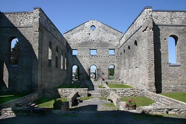 Church nave, interior view of neglected walls, foundation with grass