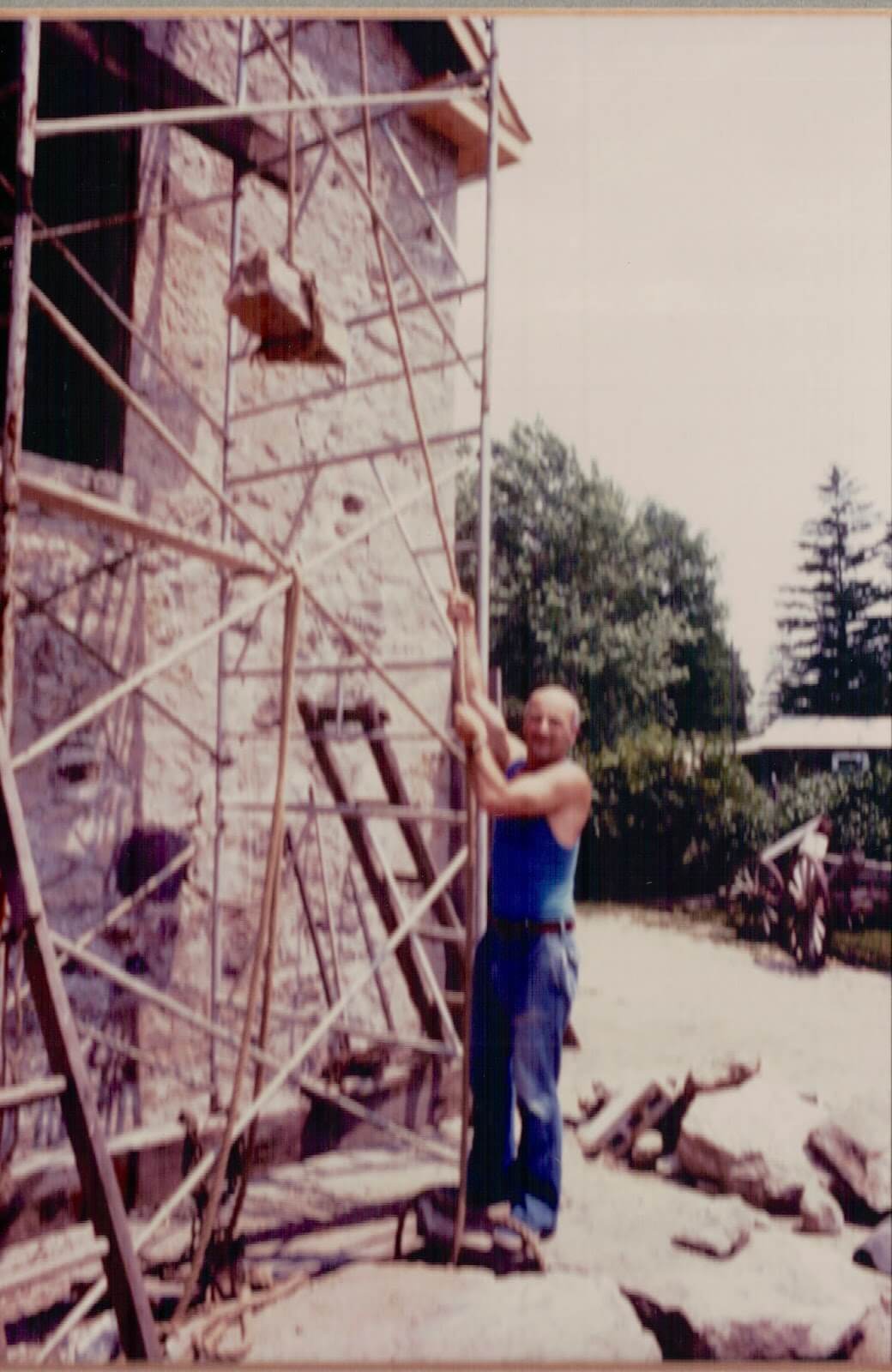 A man, Josef Drenters, works on the scaffolding of the Rockwood Academy Gynasium wing