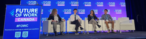 Panelists sitting on stage at the future of work conference