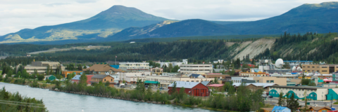 A view of a city in Northern Canada where buildings sit alongside a bay