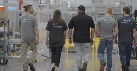 Automation Tooling Systems (ATS) employees walking in a group