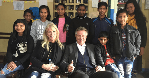 Michael and his spouse Stacey with a group of children in India