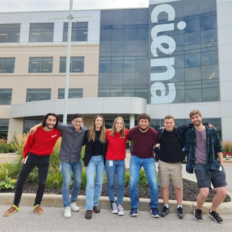 Ciena staff and Waterloo co-op students standing infront of a Ciena building