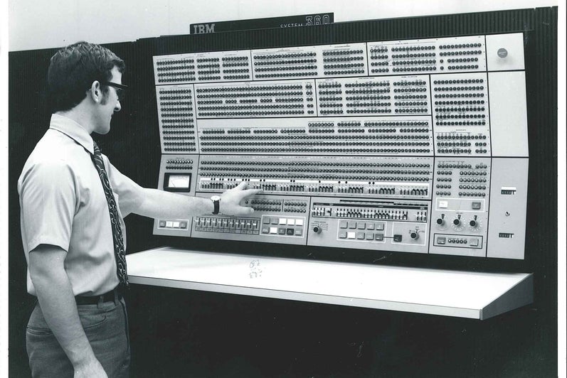 Man standing in front of IBM 360 Model 75 computer 