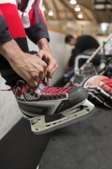 A Bladetech skate being tied.