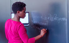 A participant writes on the blackboard