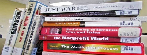 Stack of books relating to Peace and Conflict Studies