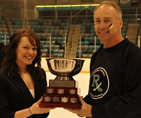 Dr. Edwards and Kacie holding a trophy smiling