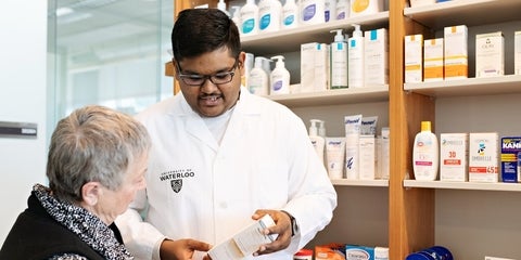 Pharmacy student talking to elderly patient