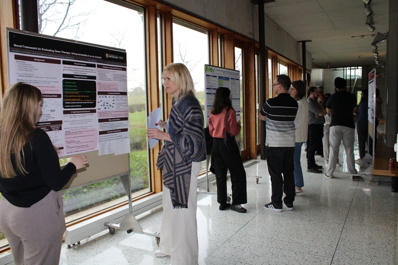 People standing in front of research posters