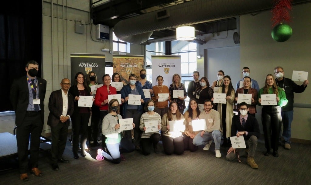 Students at faculty at the Sustainability Office awards ceremony with their certificates.