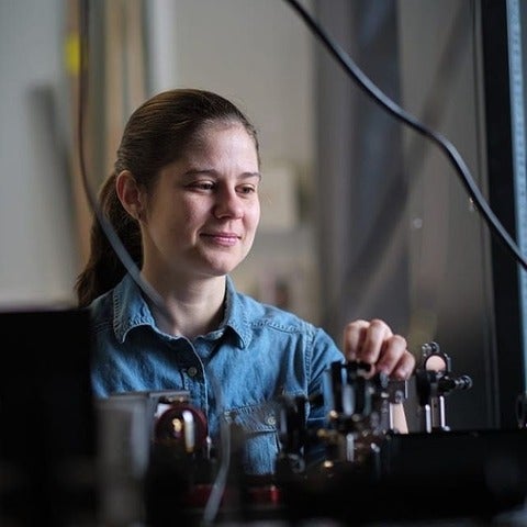 Crystal Senko adjusts optical components in her lab