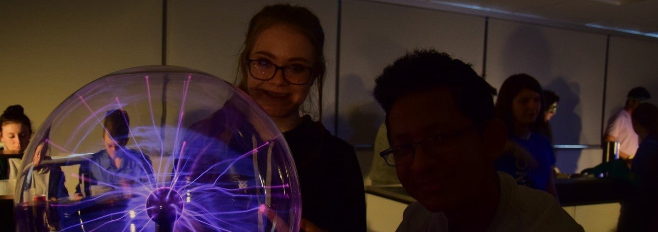 Students performing experiments with a plasma ball