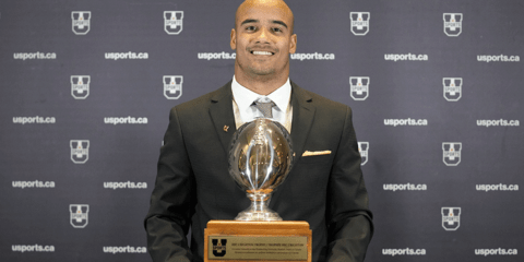 Tre Ford holding Hec Crighton trophy