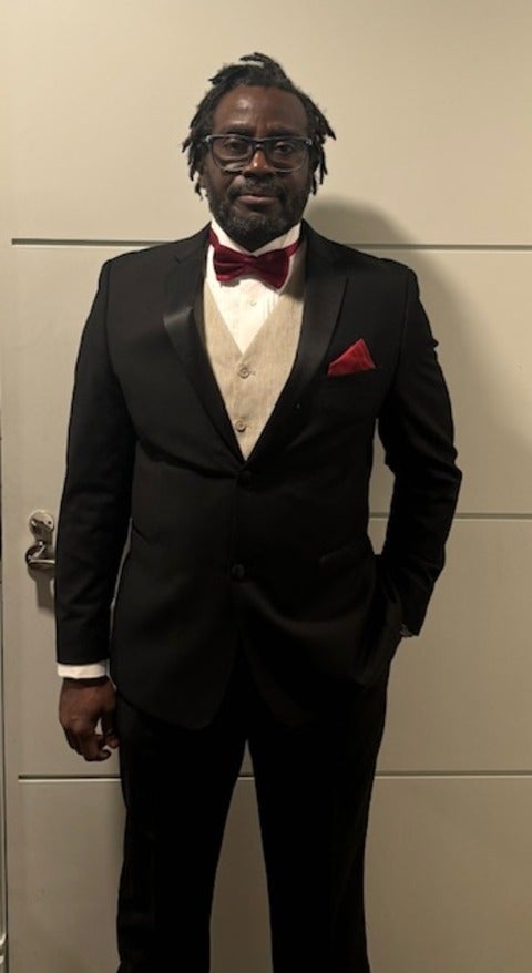 Jason Olubobokun wearing a suit. 