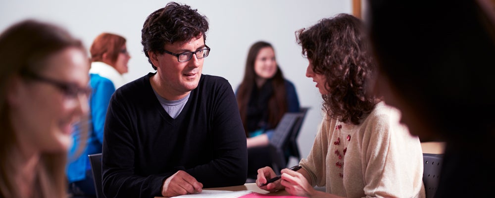 Professor Rob Case helps a student