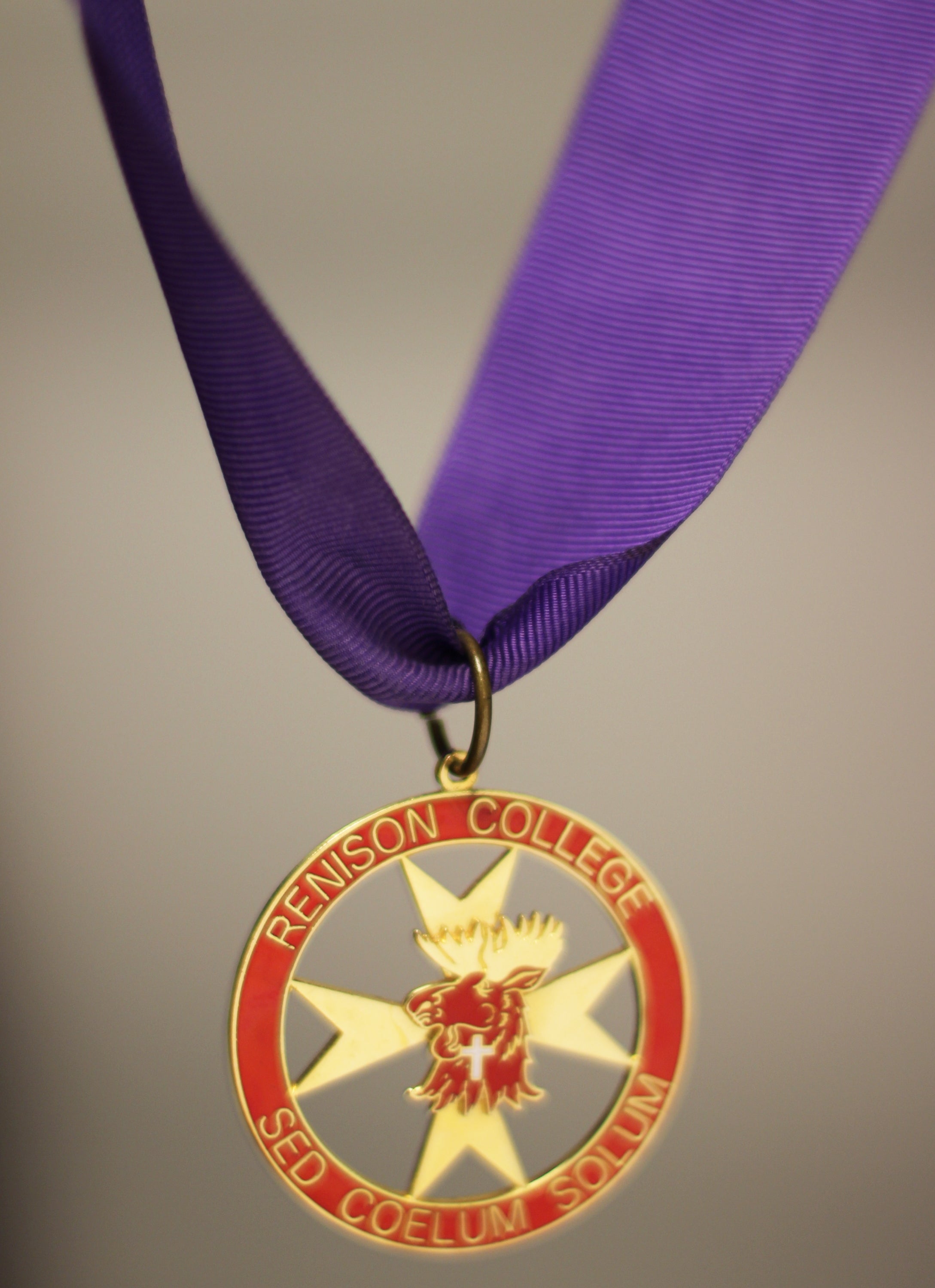 Red medal hung from a purple ribbon.
