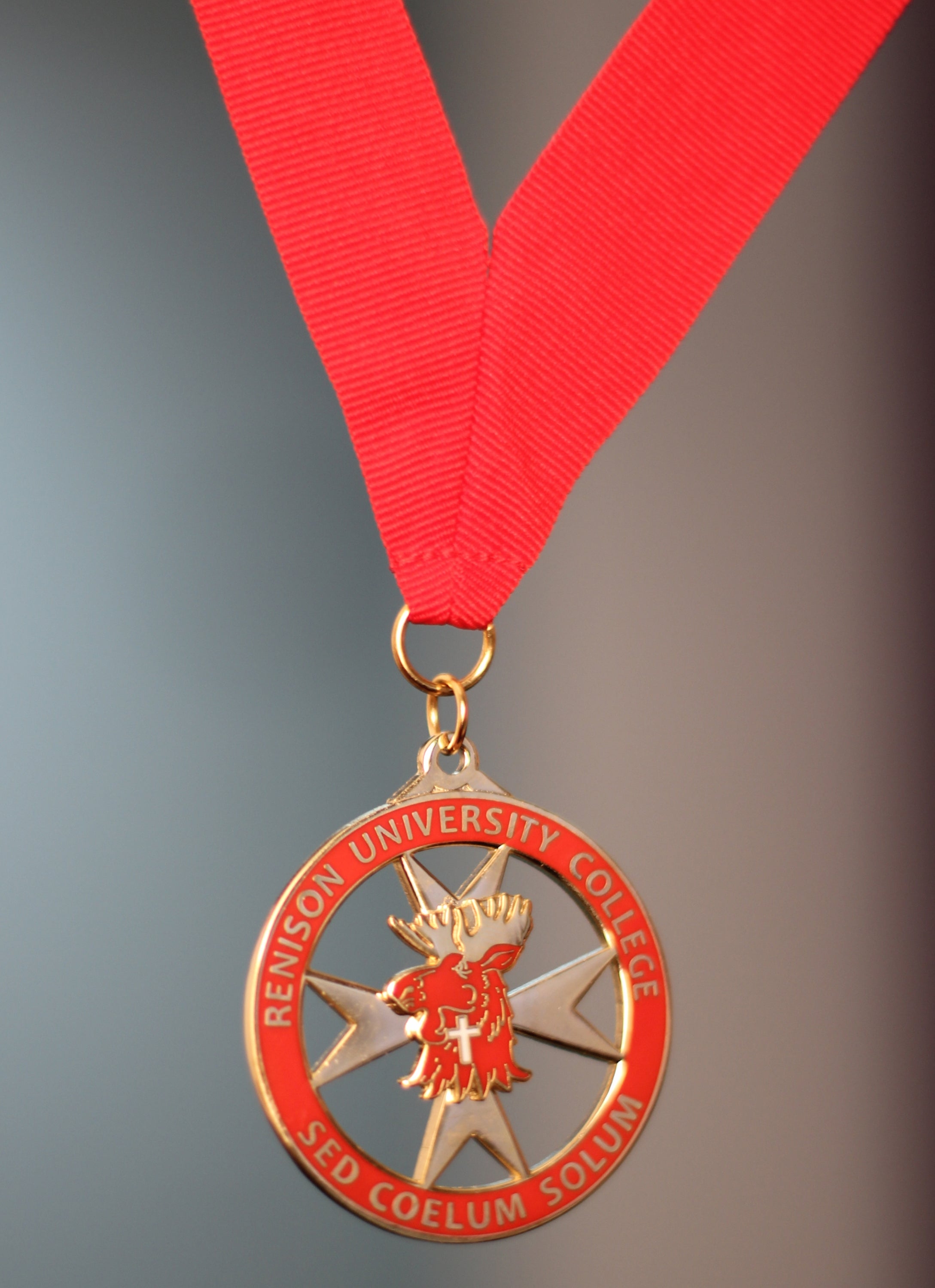 Red medal hung from a red ribbon.