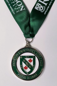Green lanyard with medal hanging. Medal has Renison shield and says "Renison University College Young Alumni"