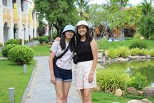 Stephanie and Jessica Nguyen outdoors wearing hats