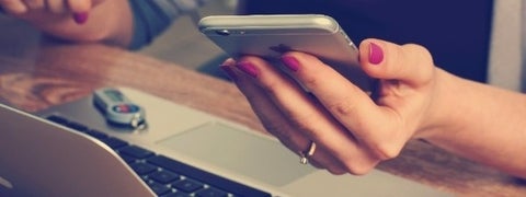 Article banner - hand holding mobile phone