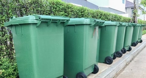 green bins on a curb