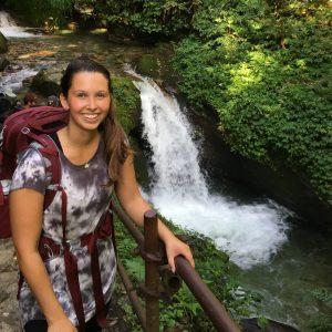 Jamie Crncich poses near a waterfall