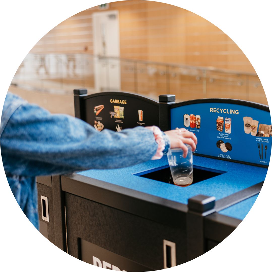 Student recycling cup at four stream receptacle