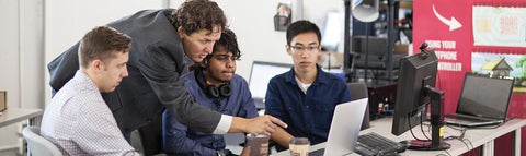 instructor and students looking at a computer