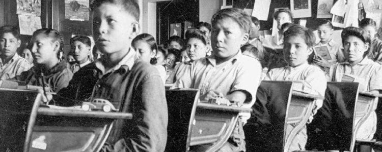 Old photo of Aboriginal children in classroom.