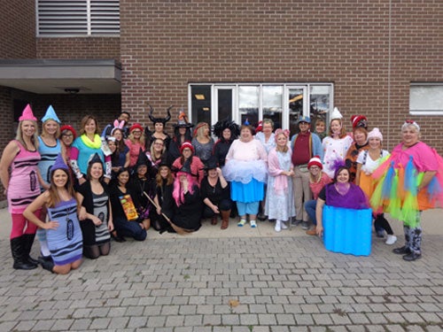 Staff members dressed up in a variety of Hallowe'en costumes
