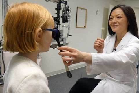 Optometrist tests a child's binocular vision